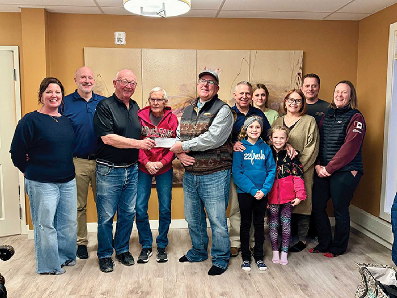 The Thorn family donated $50,000 last week to the Moosomin Airport Expansion Project. From left are Randi Thorn, Ryan Thorn, Bill Thorn, Phyllis Thorn, RM of Moosomin Reeve David Moffatt, Tyler Thorn with children Anika and Jessa, Ava Michael, Angela Thorn, Tyler Michael, and Gloria Thorn.
